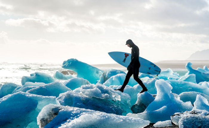 Surfer walking on ice