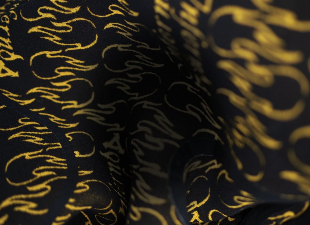 Close-up of black wetsuit lining printed with a yellow flame pattern