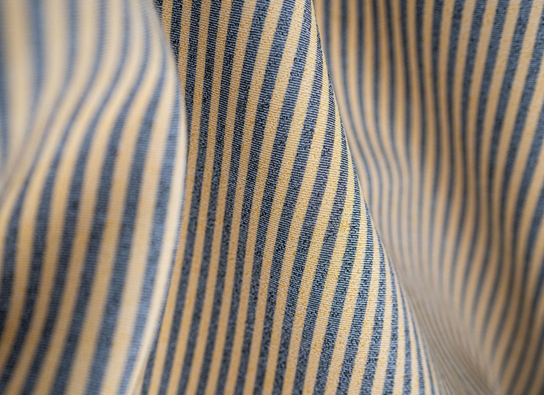 Close-up of quick-drying wetsuit lining striped in gold and navy