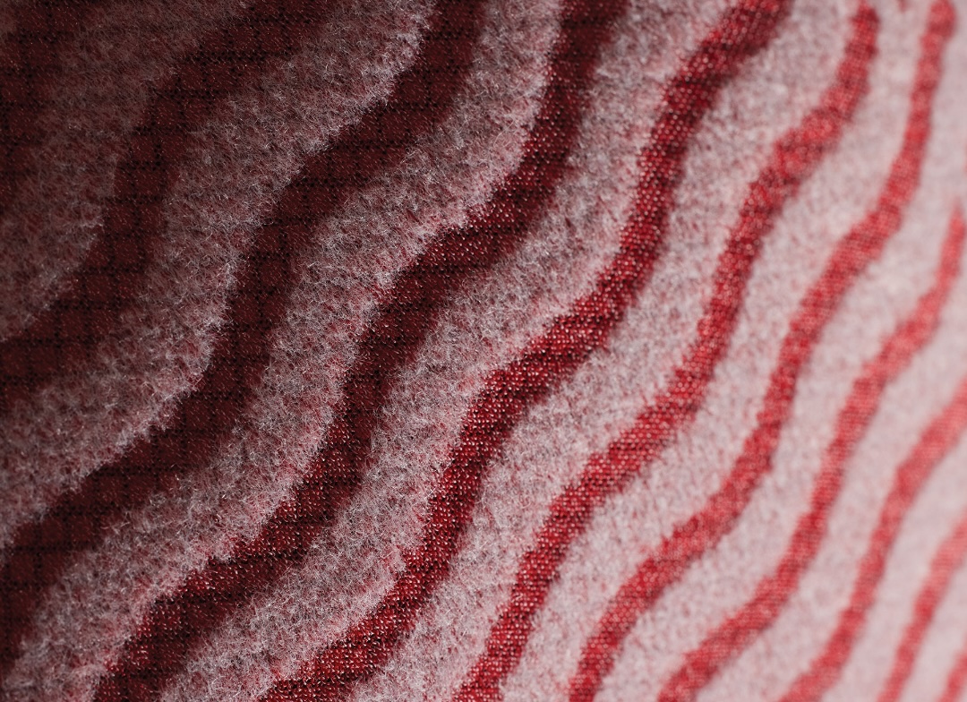 Close-up of soft thermal wetsuit lining with wavy red and pink stripes