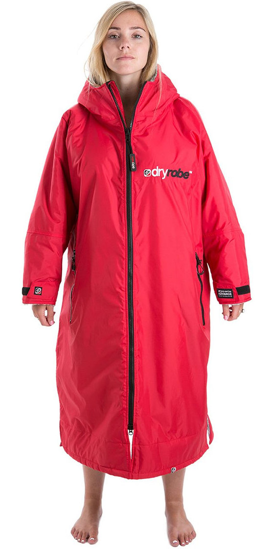 Woman modelling a red long-sleeved dryrobe change robe with the hood up, studio shot on white